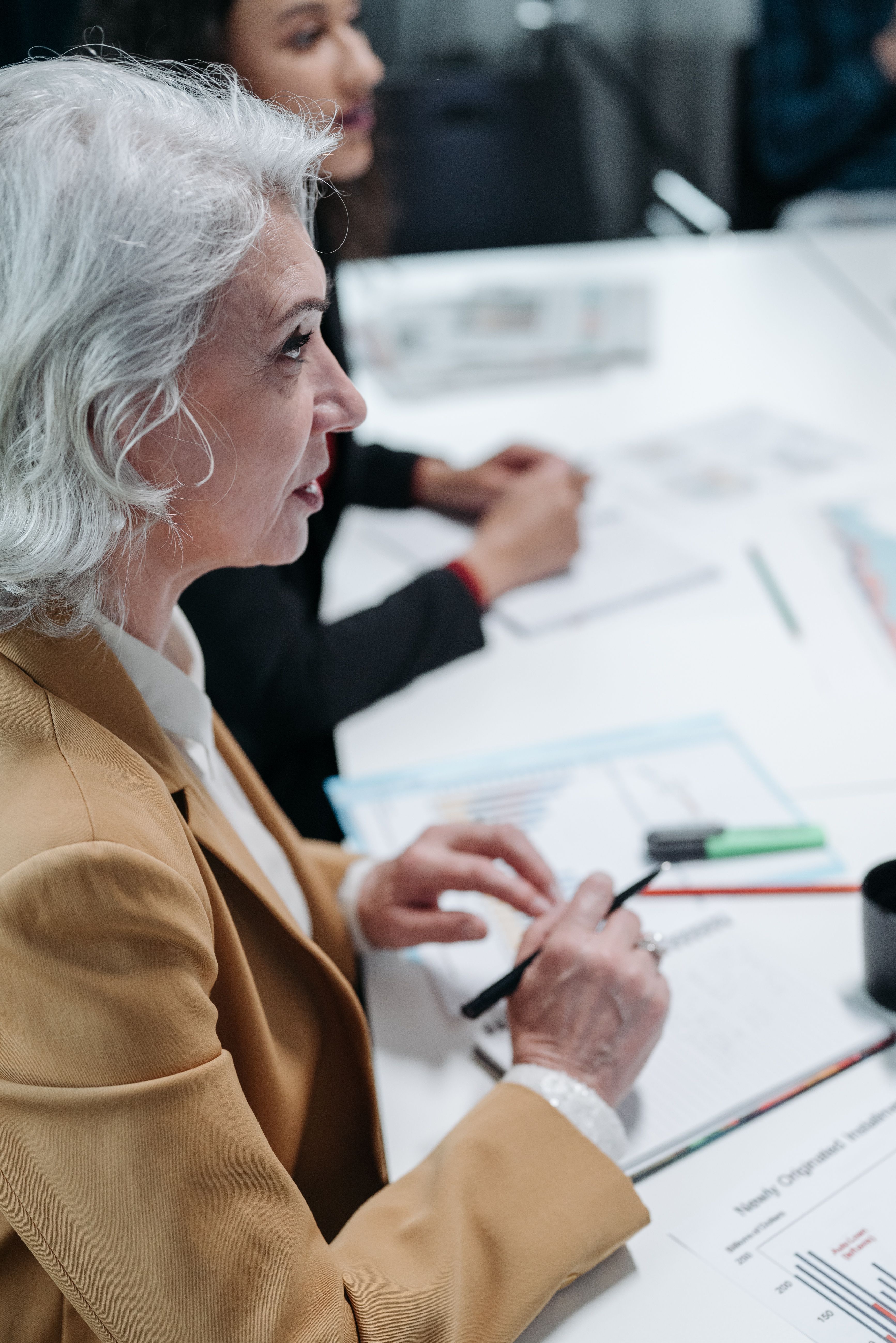 Businesswoman taking notes at a meeting table