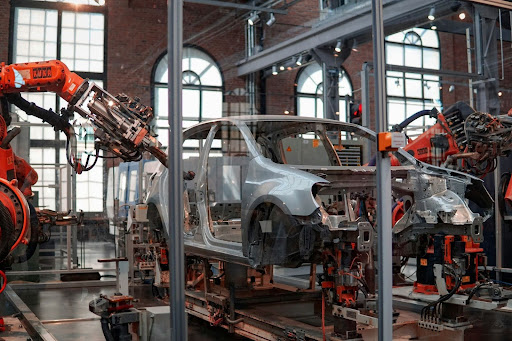 Automated automotive production line with robotic assembly Industrial robots assembling a car body on an automotive manufacturing line, representing workplace safety, automation, and modern vehicle production.