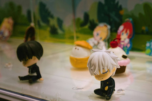 Playful collectible figurines as desk decor Small collectible character figurines displayed together, representing playful desk decor and personal expression in a modern workspace.