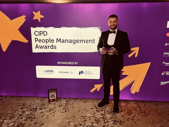 Christopher Brennan holding his commendation at the CIPD People Management Awards