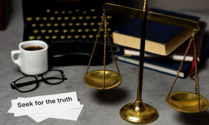 Scales of justice on a lawyer’s desk with law books, glasses, and paperwork, symbolising accuracy, compliance, and financial balance in law firm bookkeeping. 
