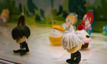 Small collectible character figurines displayed together, representing playful desk decor and personal expression in a modern workspace.