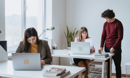 Colleagues collaborating around laptops in an office — photo by olia danilevich, Pexels